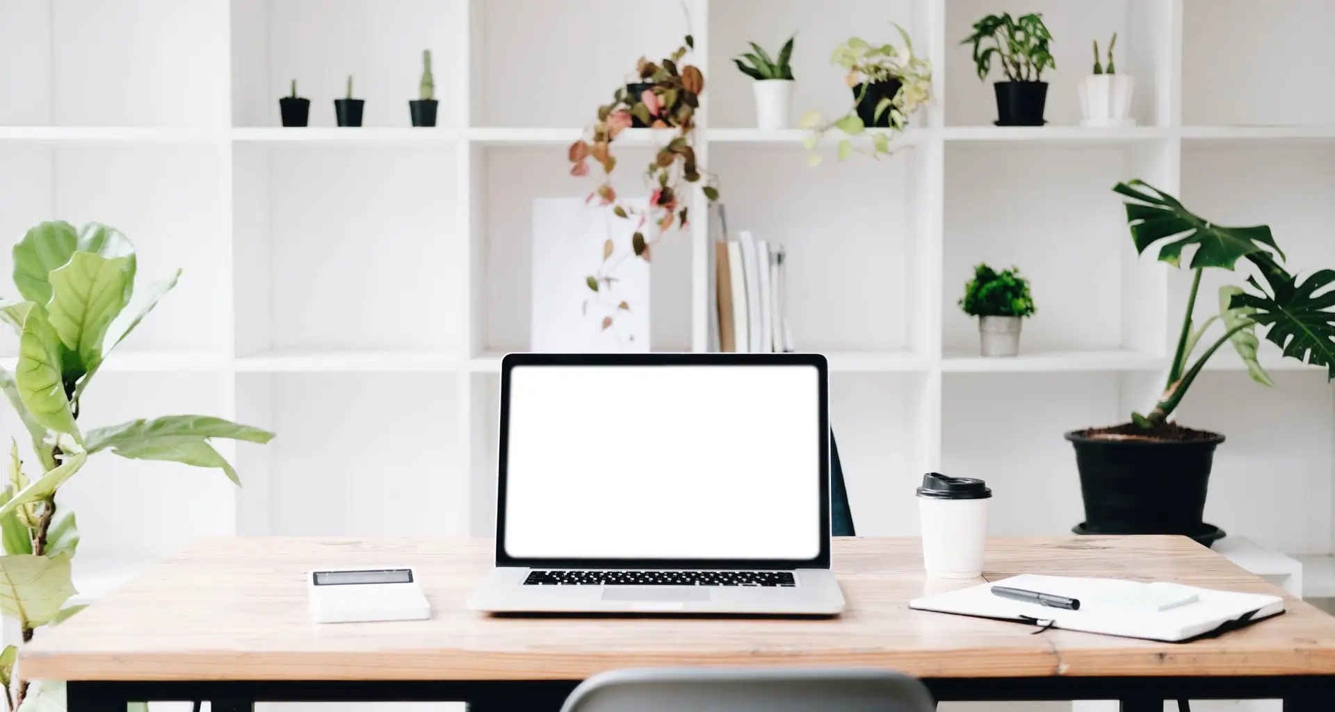 Workplace mockup concept. Mock up modern home decor desktop computer with vintage books, houseplant. Artist workspace with copy space for products display montage.Mockup desktop.
